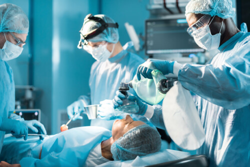 african american anesthetist holding oxygen mask above patient