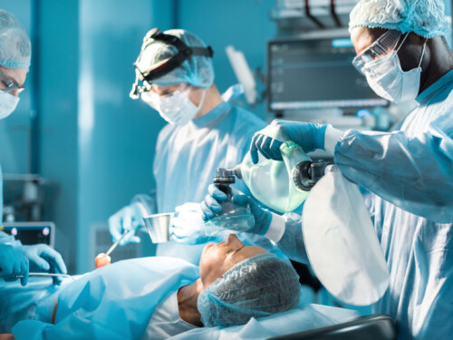 african american anesthetist holding oxygen mask above patient