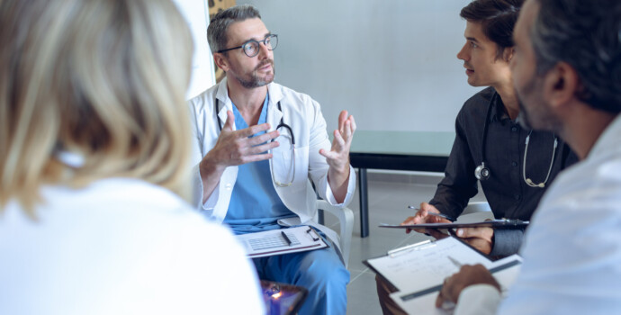 Medical team discussing with each other in hospital