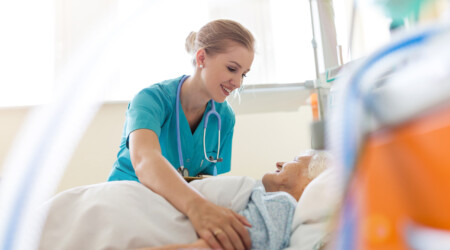 Senior patient and nurse in hospital