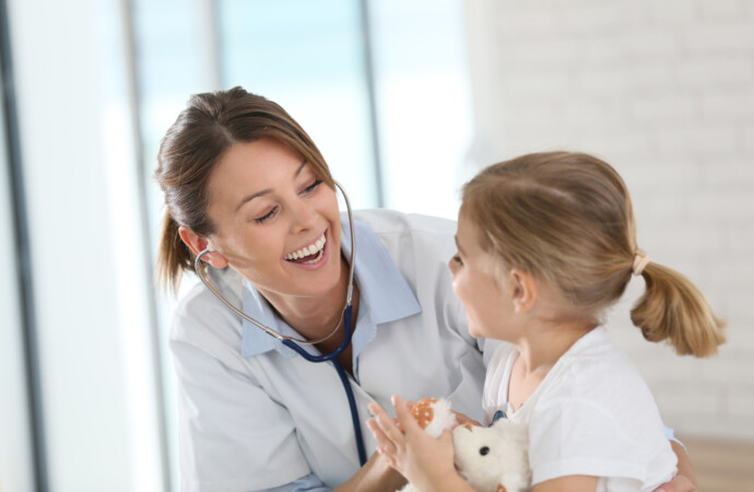 Doctor examining little girl with stethoscope