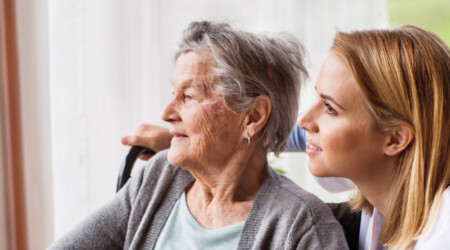 Health visitor and a senior woman during home visit.