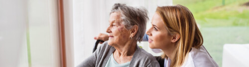 Health visitor and a senior woman during home visit.