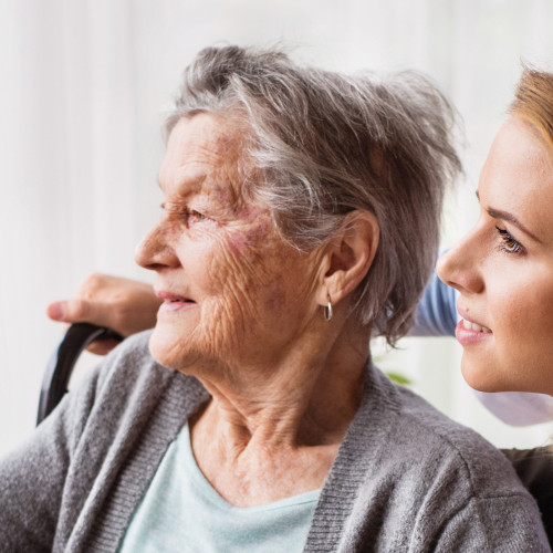 Health visitor and a senior woman during home visit.