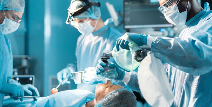 african american anesthetist holding oxygen mask above patient