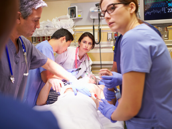 Medical Team Working On Patient In Emergency Room