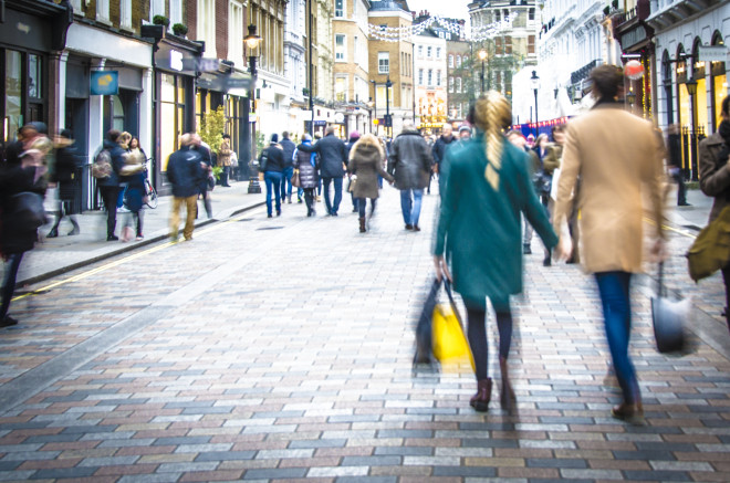 Motion blurred couple on shopping street