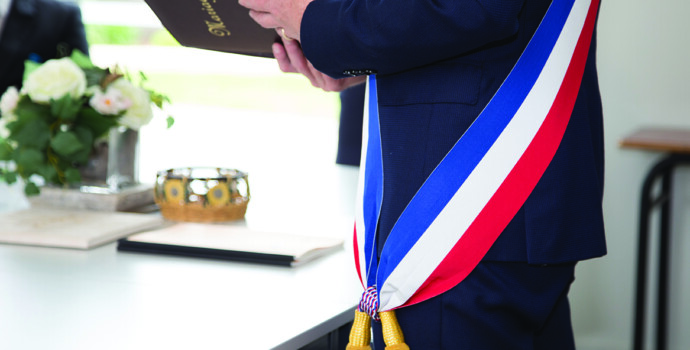 French mayor with a scarf flag during a weeding day