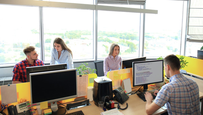 Team working in office. Monitor typing and new project discussing.