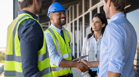 Engineer and businessman handshake at construction site