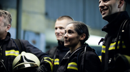 Group of professional firefighters wearing full equipment. relax