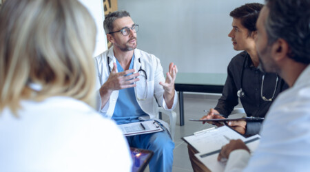 Medical team discussing with each other in hospital