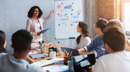 Professional marketologist making presentation during business meeting with colleagues