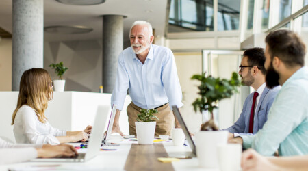 Senior boss holds a meeting for younger colleagues