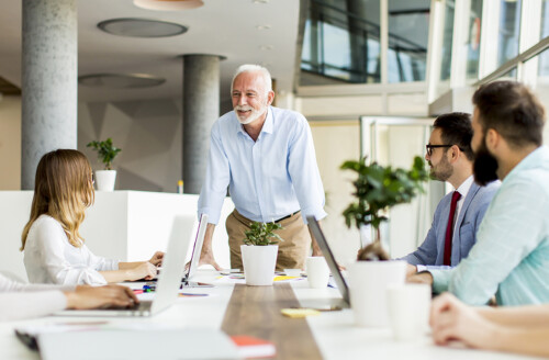 Senior boss holds a meeting for younger colleagues