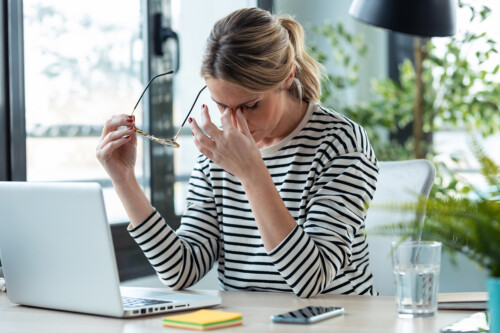 Stressed mature business woman looking worried, tired and overwh