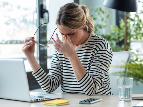 Stressed mature business woman looking worried, tired and overwh