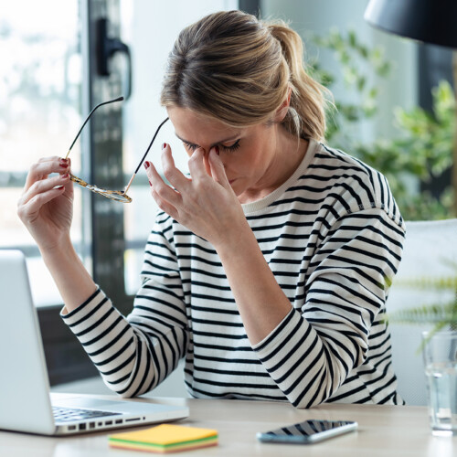 Stressed mature business woman looking worried, tired and overwh