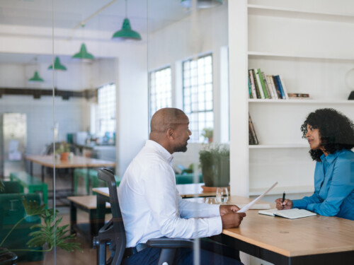 Manager interviewing a potential new employee in her office