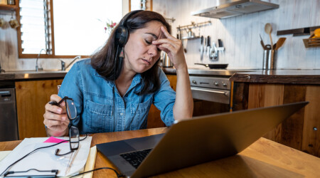 Attractive young business woman working from home on her compute