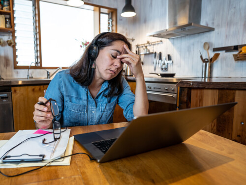 Attractive young business woman working from home on her compute