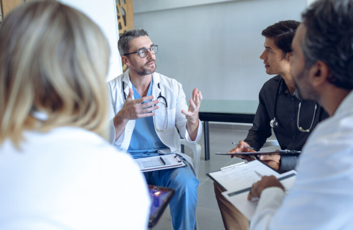 Medical team discussing with each other in hospital