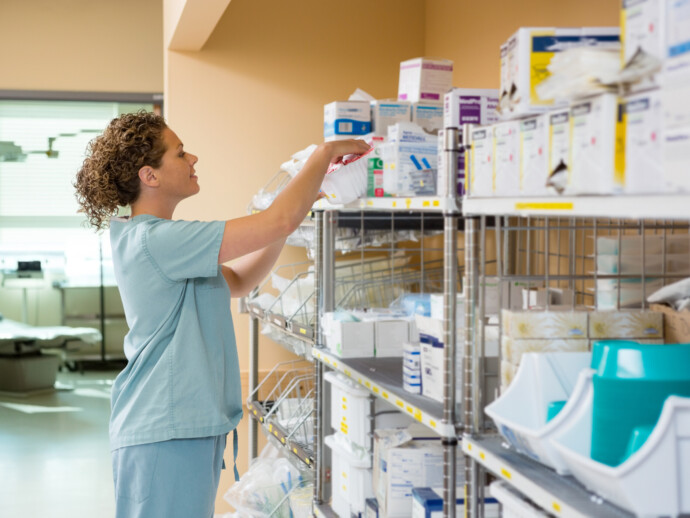 Female Nurse Working In Storage Room