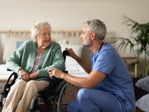 Caregiver doing regular check-up of senior woman in her home.
