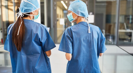 Two women as surgeons in blue surgical clothing