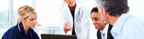 Female Doctor talking to businessmen and nurse in meeting