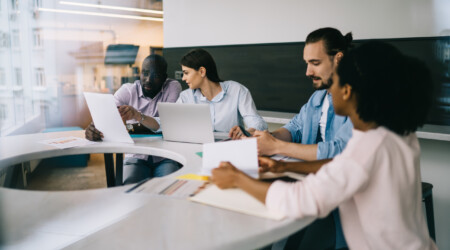 Work team checking papers at meeting in office