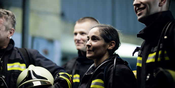 Group of professional firefighters wearing full equipment. relax