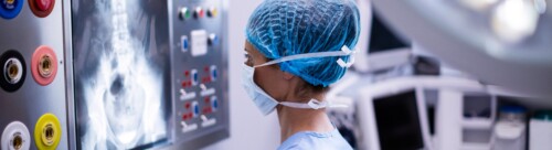 Female surgeon reading x-ray