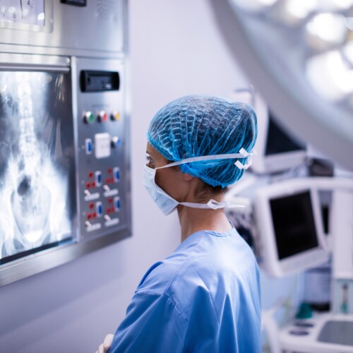 Female surgeon reading x-ray