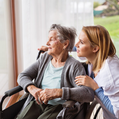 Health visitor and a senior woman during home visit.