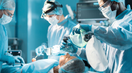 african american anesthetist holding oxygen mask above patient