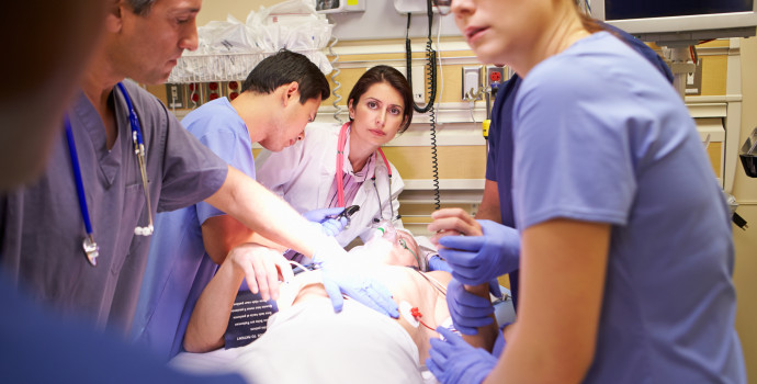 Medical Team Working On Patient In Emergency Room