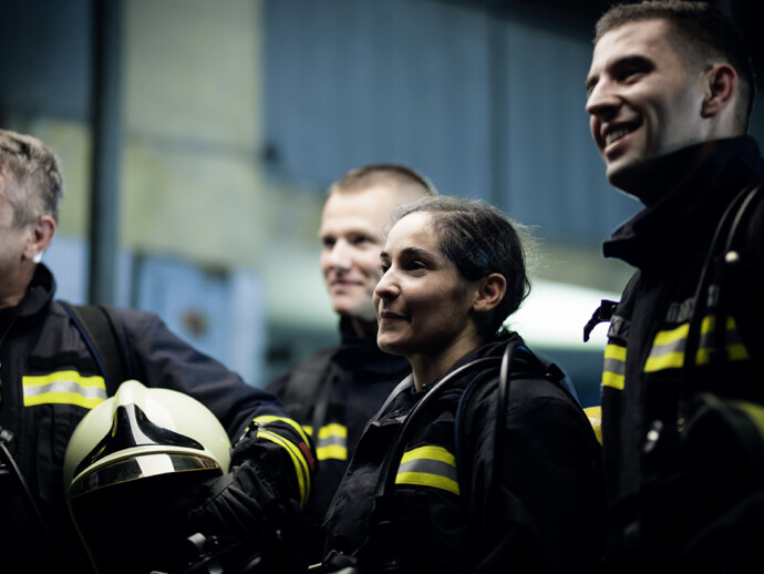 Group of professional firefighters wearing full equipment. relax