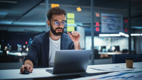 Successful Handsome Creative Director Working on Laptop Computer