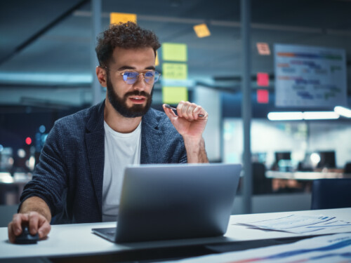 Successful Handsome Creative Director Working on Laptop Computer