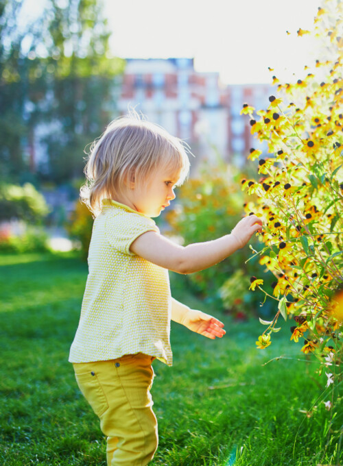 Adorable toddler girl having fun in park