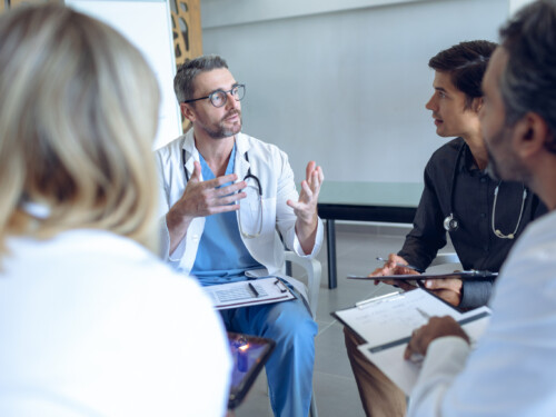 Medical team discussing with each other in hospital