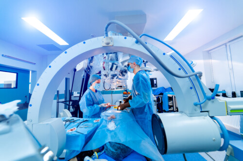 Manipulators performing surgery on a patient. Medical robot. Robotic Surgery. Medical operation involving robot.