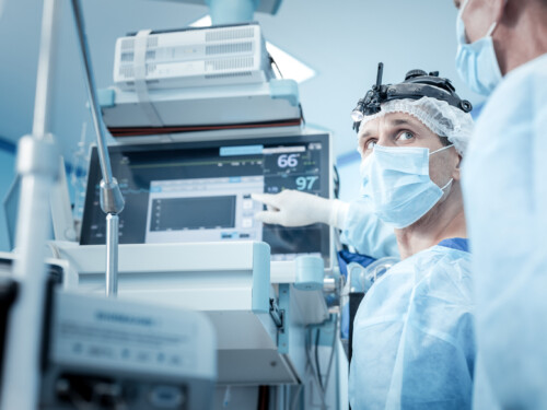 Serious male surgeon pointing at the screen