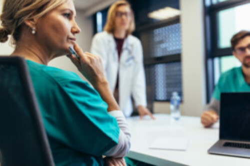 Female medical professional in staff meeting