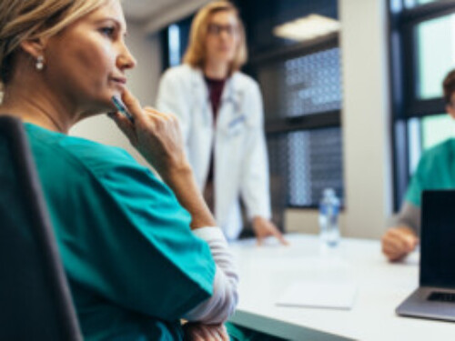 Female medical professional in staff meeting