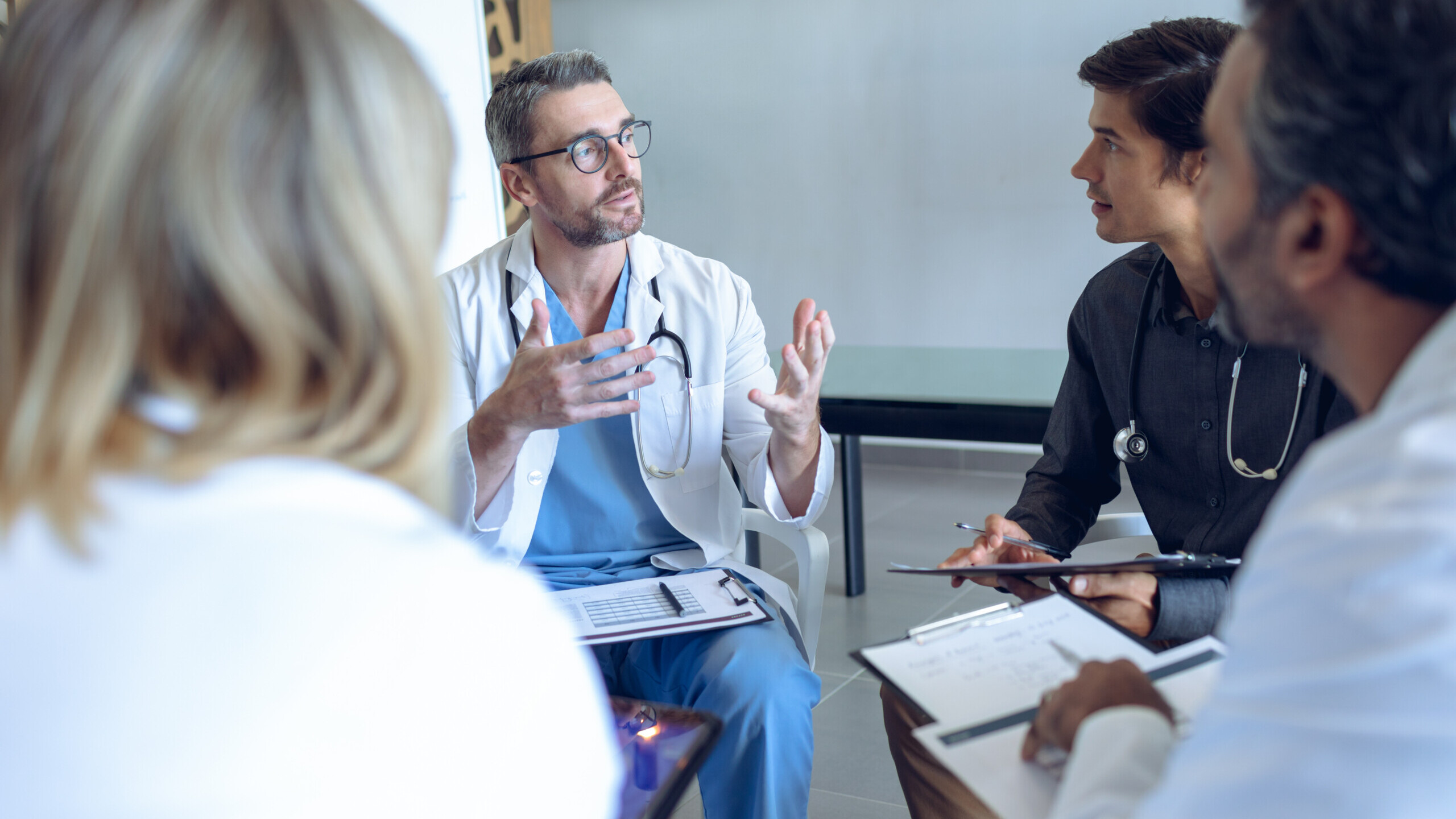 Medical team discussing with each other in hospital